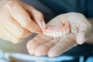 flexible dentures on a person's palm flexible dentures on a person's palm
